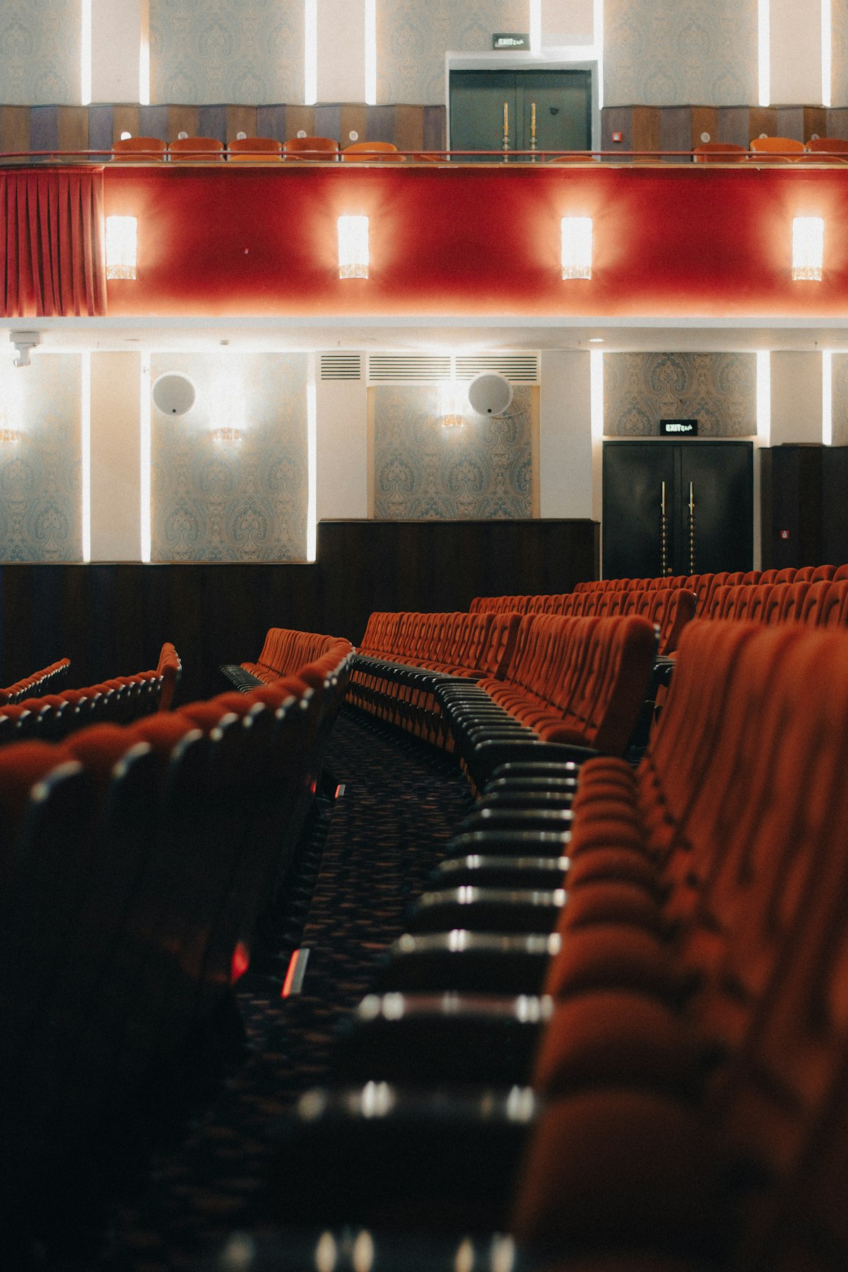 Rows of red velvet seats in a classic cinema auditorium